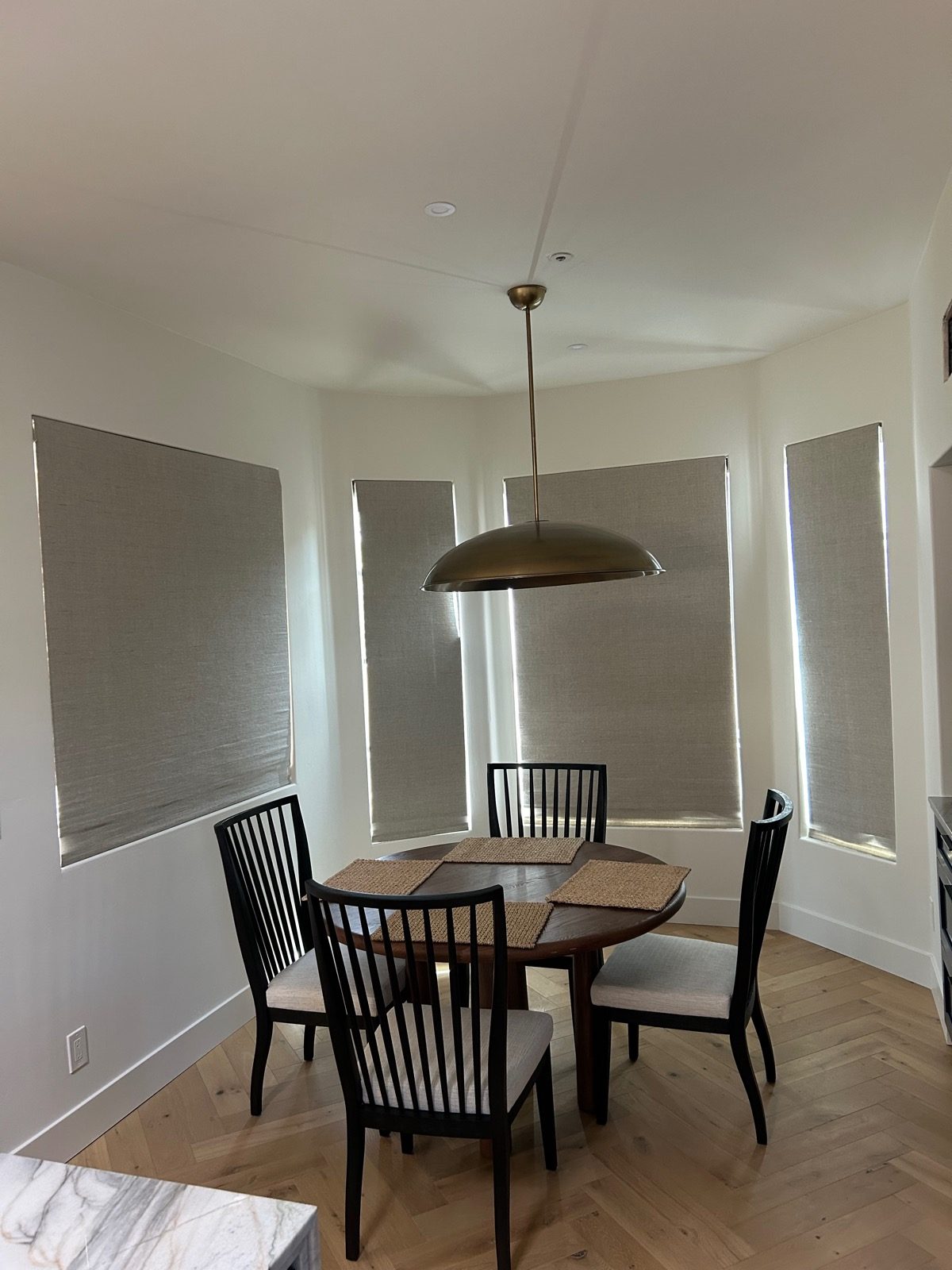 Cordless roller shades with clean bottom rails in a Tucson dining nook