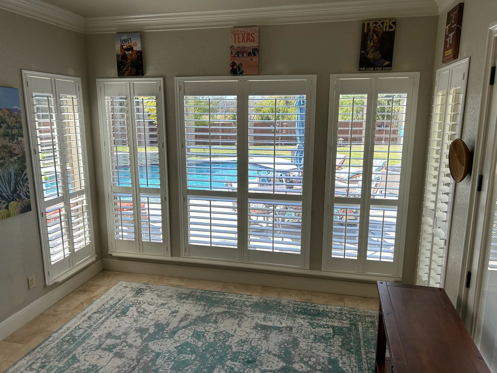 White plantation shutters installed in a bright Tucson living room